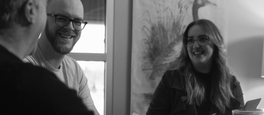 People smiling at an office table